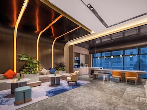A modern lobby with a curved seating area, a bar, and large windows offering a view of the city. - Holiday Inn Express Changzhou Henglin (Changzhou)