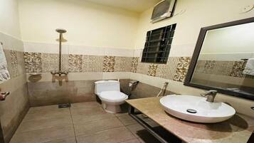 A bathroom with a toilet, sink, and shower.