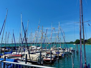 A marina with numerous sailboats docked, surrounded by calm water and clear skies. - Reutemann Guesthouse WG2 - Cozy vacation rental in a quiet, central location (Nonnenhorn)