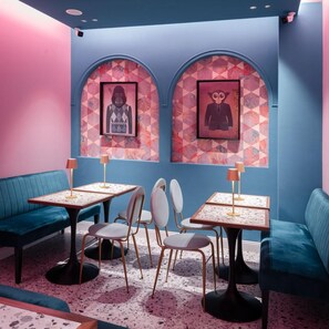 A room with teal sofas, a coffee table, and chairs. There are two framed pictures on the wall. - THE Steps Hotel by Eitch Collection (Rome)