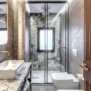 A modern bathroom with a glass-enclosed shower, a standalone sink, and a toilet. - THE Steps Hotel by Eitch Collection (Rome)