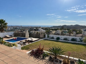 A rooftop pool area with a view of the city and hills. - Stunning 4-Bedroom Villa | Private Pool & Ocean Views | Mijas Costa (Las Lagunas de Mijas)