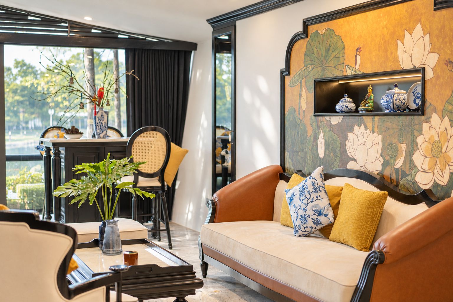 A modern living room with a sofa, a coffee table, and a dining area with chairs and a table.