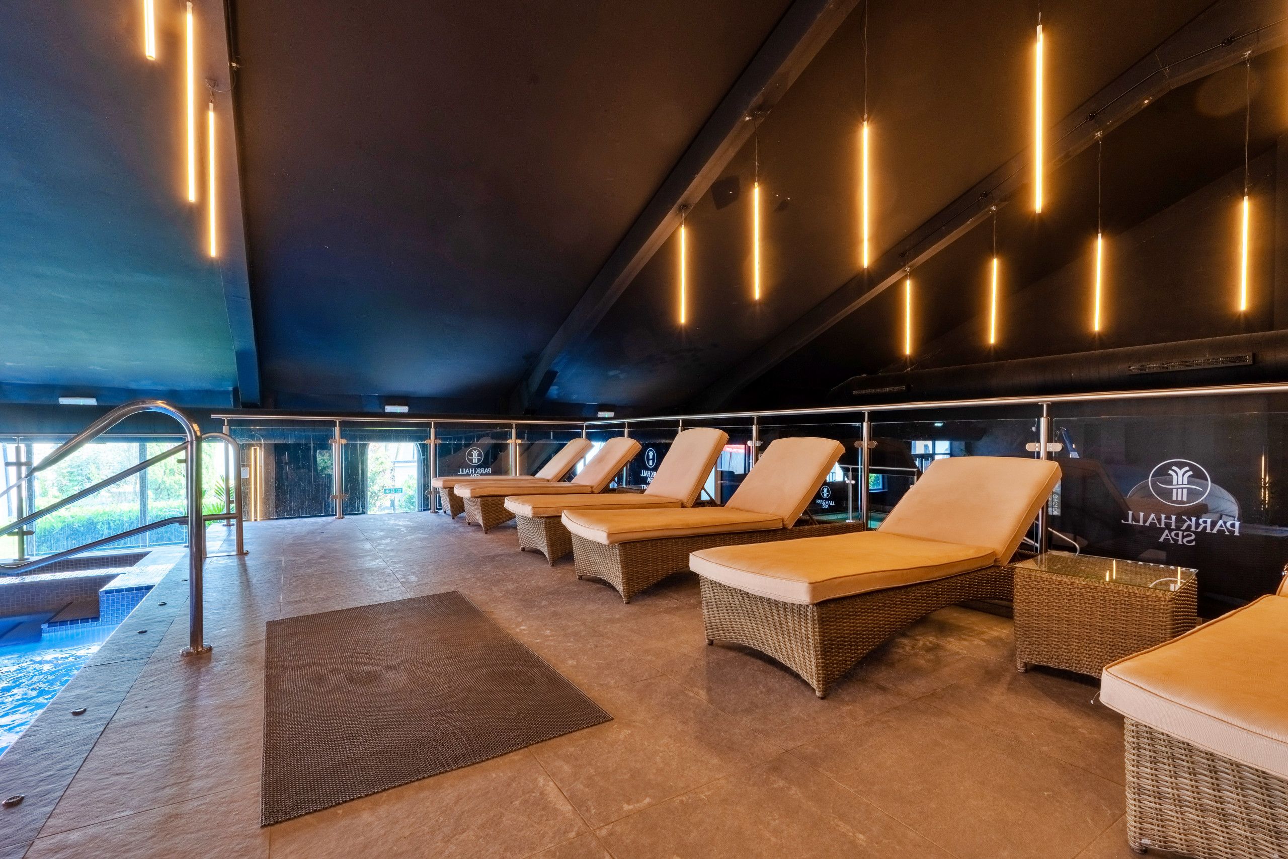 A spa area with lounge chairs and a pool.