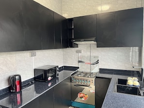 Standard Apartment, Patio | Private kitchen | Mini-fridge, microwave, oven, stovetop - Inkingi Homestay (Kigali)