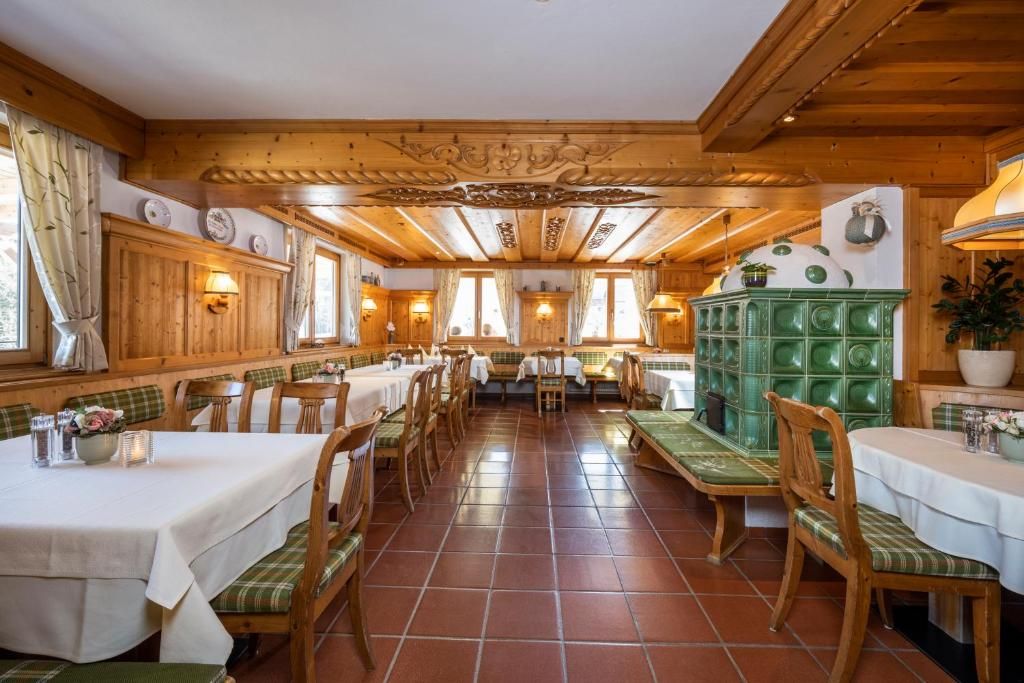 A restaurant with wooden interior, multiple tables, and benches.