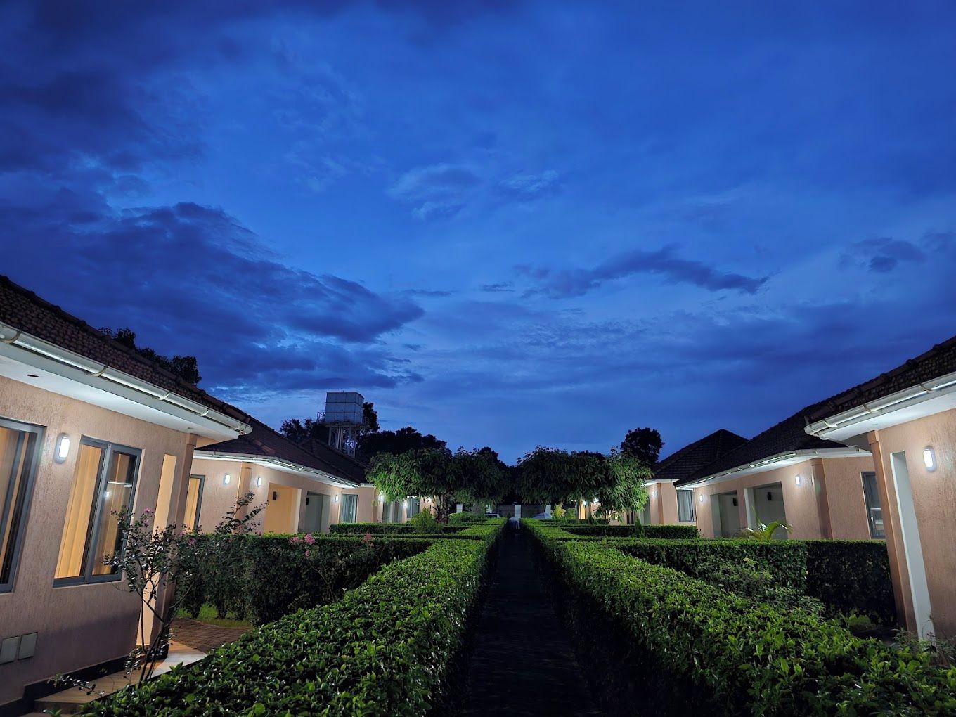 A pathway leading to a row of buildings with a clear sky overhead.