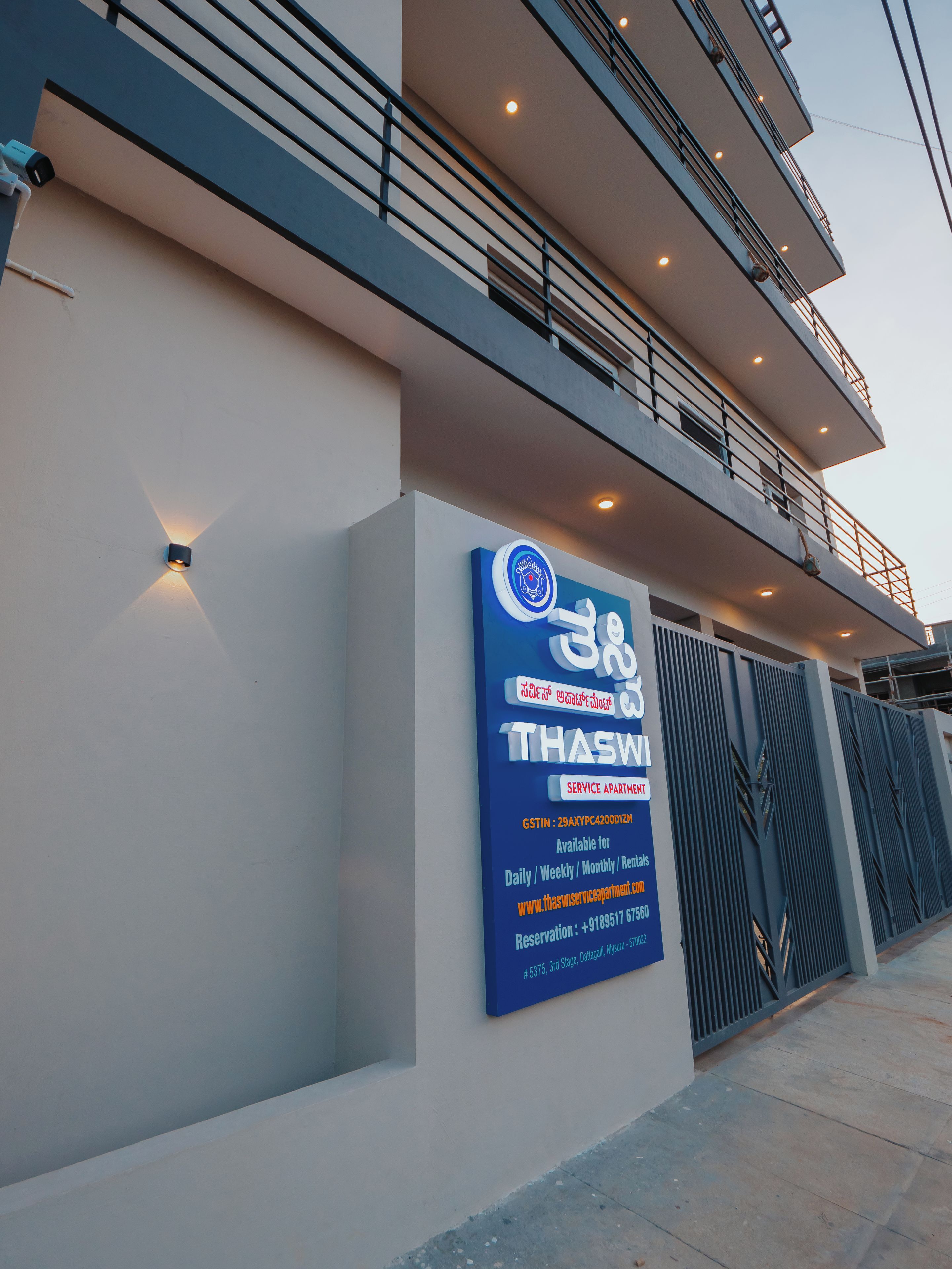 A modern building with a signboard indicating a service apartment.
