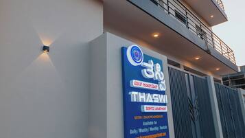 A modern building with a signboard indicating a service apartment.