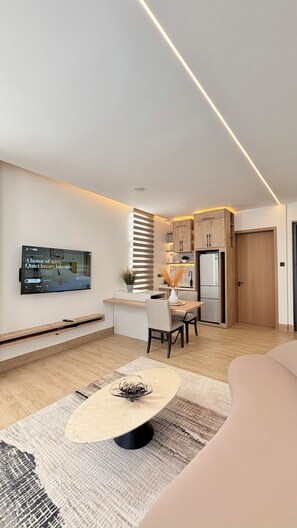 A modern kitchen with wooden cabinets, a built-in oven, and a refrigerator.