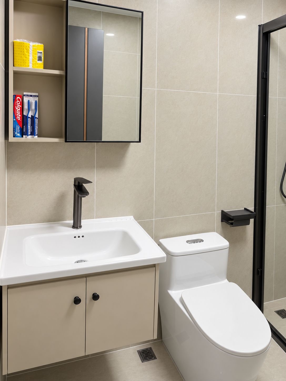 A modern bathroom with a white sink, a toilet, and a mirror above the sink.