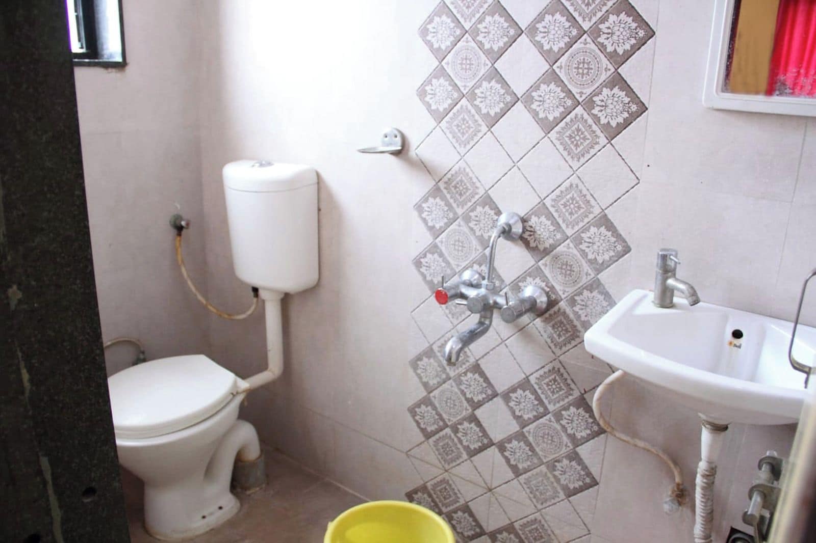 A bathroom with a toilet, a sink, and a shower.