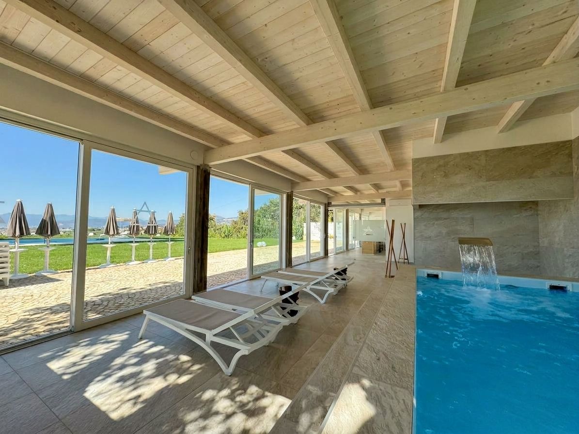A poolside area with lounge chairs and a view of a pool.