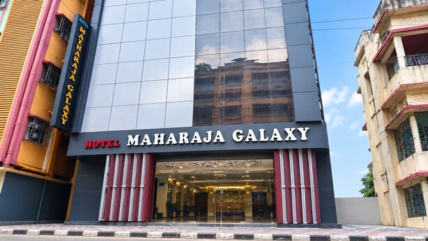 A modern hotel facade with a large glass window and a sign reading 'HOTEL MAHARAJA GALAXY'. - Hotel Maharaja Galaxy (Kolkata)