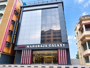 A modern hotel facade with a large glass window and a sign reading 'HOTEL MAHARAJA GALAXY'. - Hotel Maharaja Galaxy (Barakpur)
