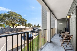 A balcony with a view of a street and parked cars, a railing, and outdoor furniture. - A129 at the Myrtle Beach Resort (Myrtle Beach)