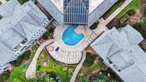 A residential area with a swimming pool surrounded by lounge chairs and a covered patio. - A239 at The Myrtle Beach Resort (Surfside Beach)