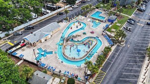 An aerial view of a resort with multiple swimming pools, lounge areas, and a parking lot. - A239 at The Myrtle Beach Resort (Surfside Beach)