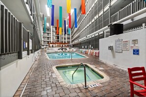 An indoor swimming pool area with multiple pools, a brick floor, and safety signs. - B141 at The Myrtle Beach Resort (Myrtle Beach)