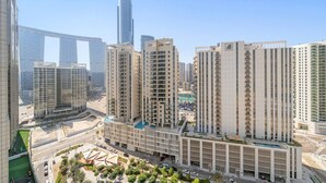 A high-rise residential building with multiple floors, a central courtyard, and a modern architectural design. - Vogue, Reflection near Reem Central Park & Beach (Abu Dhabi)