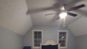 A bedroom with a bed, a ceiling fan, and a window with blinds. - Charming 3-bedroom house in Rex near Atlanta (Rex)