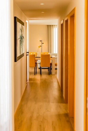 A hallway leading to a dining area with a table and chairs. - Nature Hill 1 by Portugal Active (Viana do Castelo)