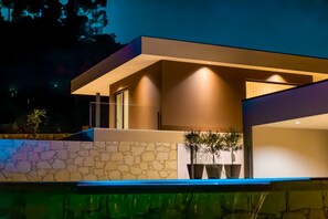 A modern house with a stone facade, large windows, and a pool. - Nature Hill 1 by Portugal Active (Viana do Castelo)