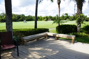 A wooden deck with benches overlooking a golf course. - Sawgrass TPC golf views (Sawgrass)