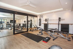 A gym with various exercise equipment, a mirrored wall, and a ceiling fan. - Exclusive & Secure, 5-Star Private Country House Estate in Constantia, Cape Town (Cape Town)