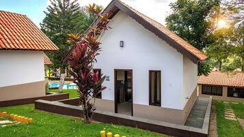 A small building with a sloped roof, a door, and a window.