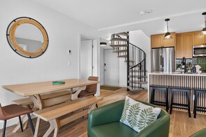A modern kitchen with a central island, wooden cabinets, and a stainless steel refrigerator. - Why You’ll Love this Colorado Escape • Ski-in/ski-out access adjacent to the Gra (Granby)