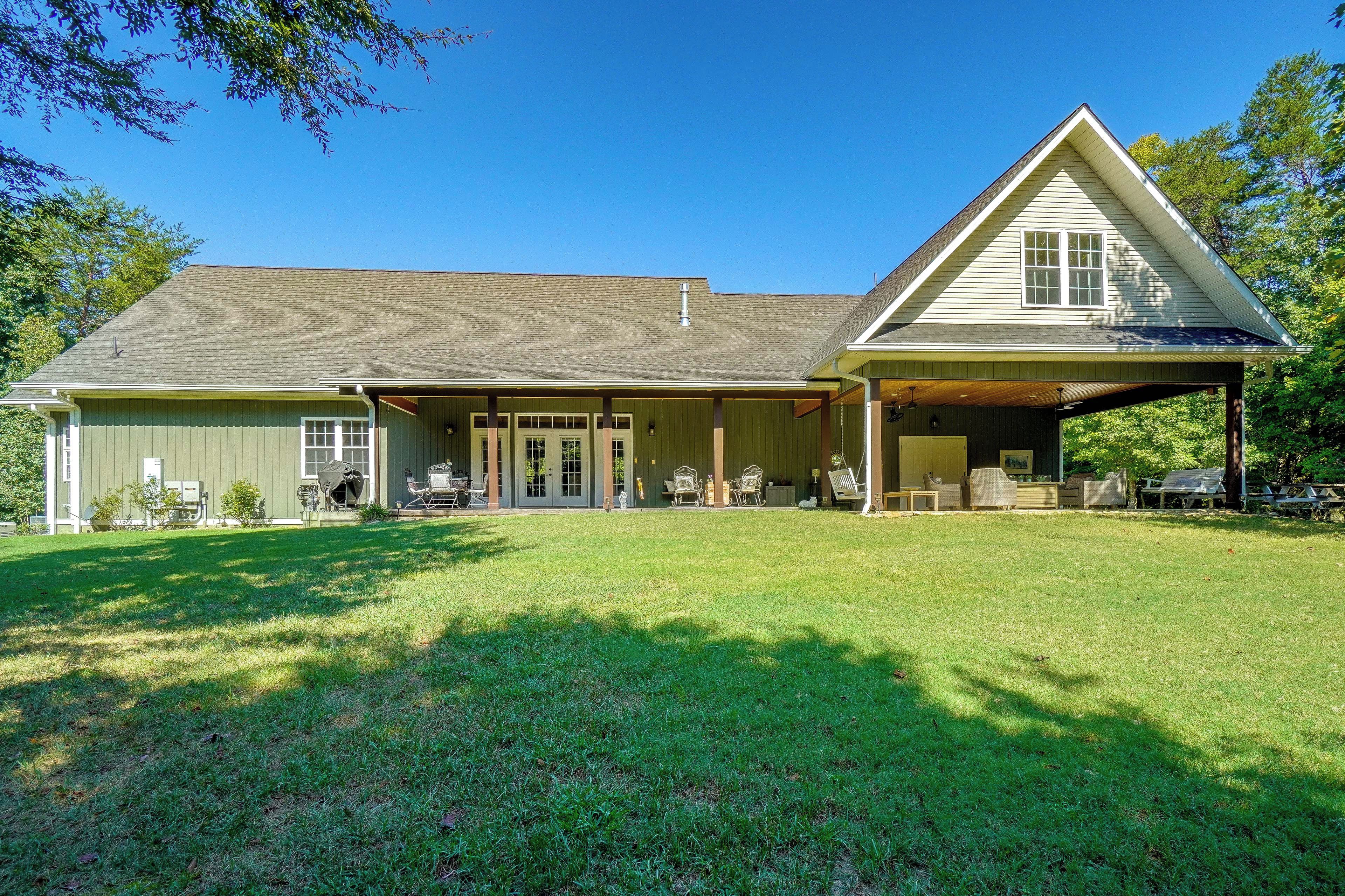 A two-story house with a covered porch and a lawn.