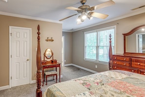 A bedroom with a bed, dresser, vanity, and a ceiling fan. - Raleigh-area Farm Stay w/ Pond: Swim, Fish, Relax! (Clayton)