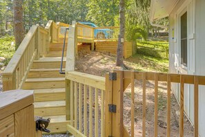 A wooden staircase leading to a deck area with a view of a blue vehicle in the background. - Massanutten Resort Home w/ Hot Tub & Game Room! (McGaheysville)