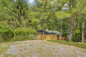 A cabin with a gravel driveway, surrounded by dense forest. - Massanutten Resort Home w/ Hot Tub & Game Room! (McGaheysville)