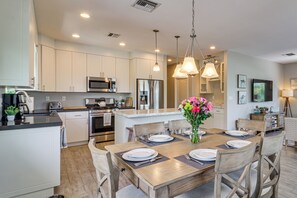 A modern kitchen with white cabinetry, stainless steel appliances, and a central island with seating. - Private Dock & Pool: Waterfront Key Largo Home (Key Largo)