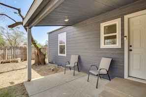 A house with a covered porch, two windows, and a door.