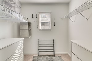 A compact walk-in closet with metal shelving, a drying rack, and a window. - 'the Haven at Northport' 5 Mi to UA Campus! (Northport)