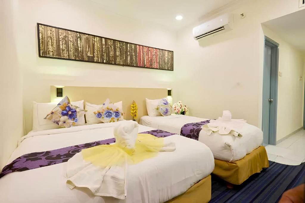 A hotel room with two beds, a large painting on the wall, and an air conditioning unit.