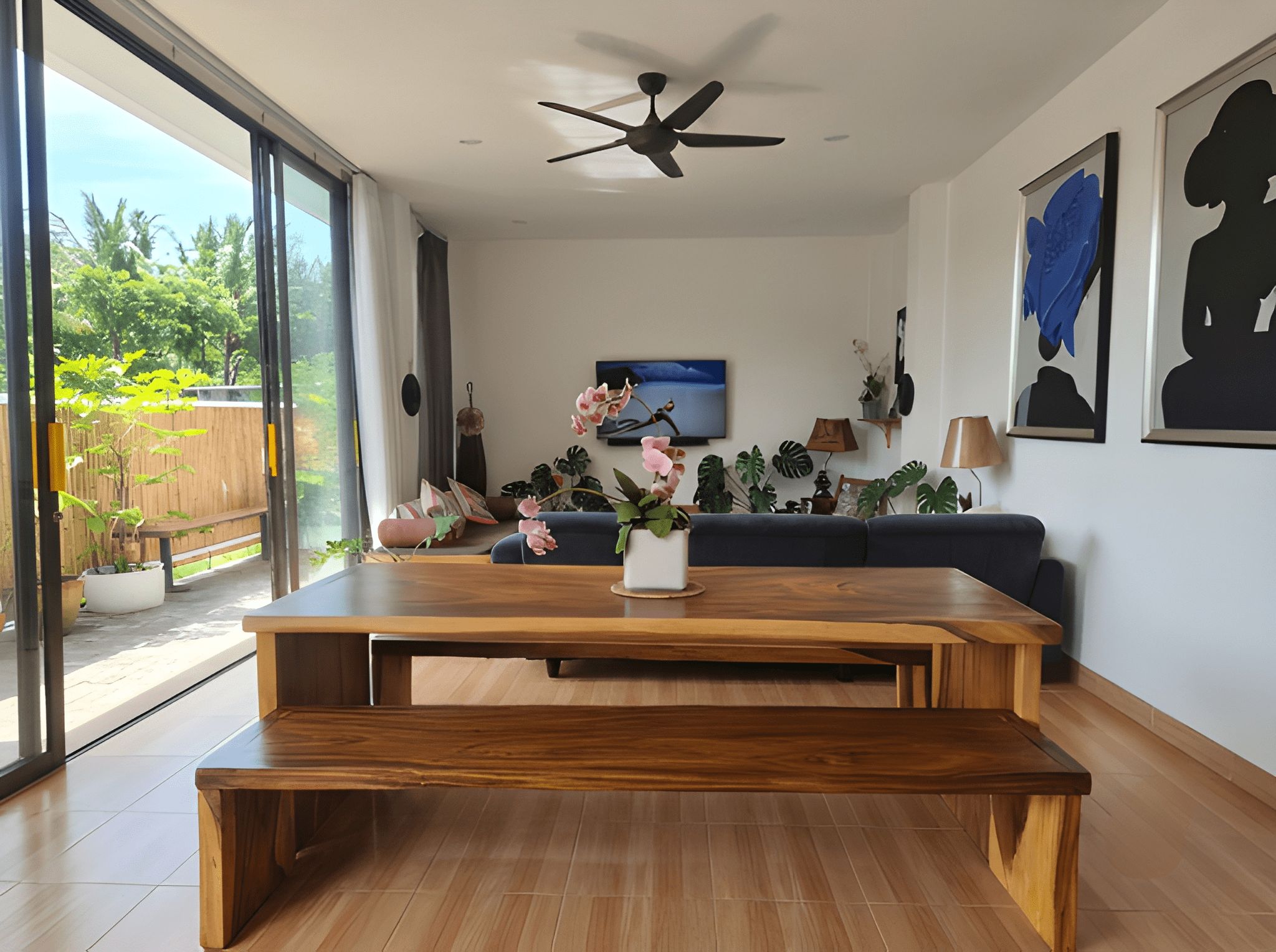 Een moderne woonkamer met een houten salontafel, een blauwe bank en een plafondventilator.