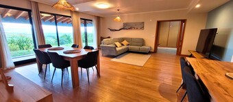 Casa Mar & Alma, featuring a panoramic ocean view from Faial's rooftop, complete with sofas and tables.