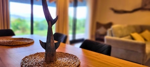 A wooden table with a woven placemat and a decorative metal piece.
