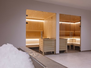 A sauna with wooden benches and a bench with a towel. - Studio for 2 People (Mittersill)