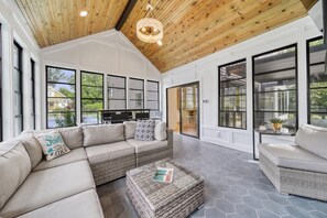 A spacious living area with a high ceiling, large windows, and a modern design. - Private Pickleball Court - Year-Round Combo Pool and Hot Tub - Beach Access (South Haven)