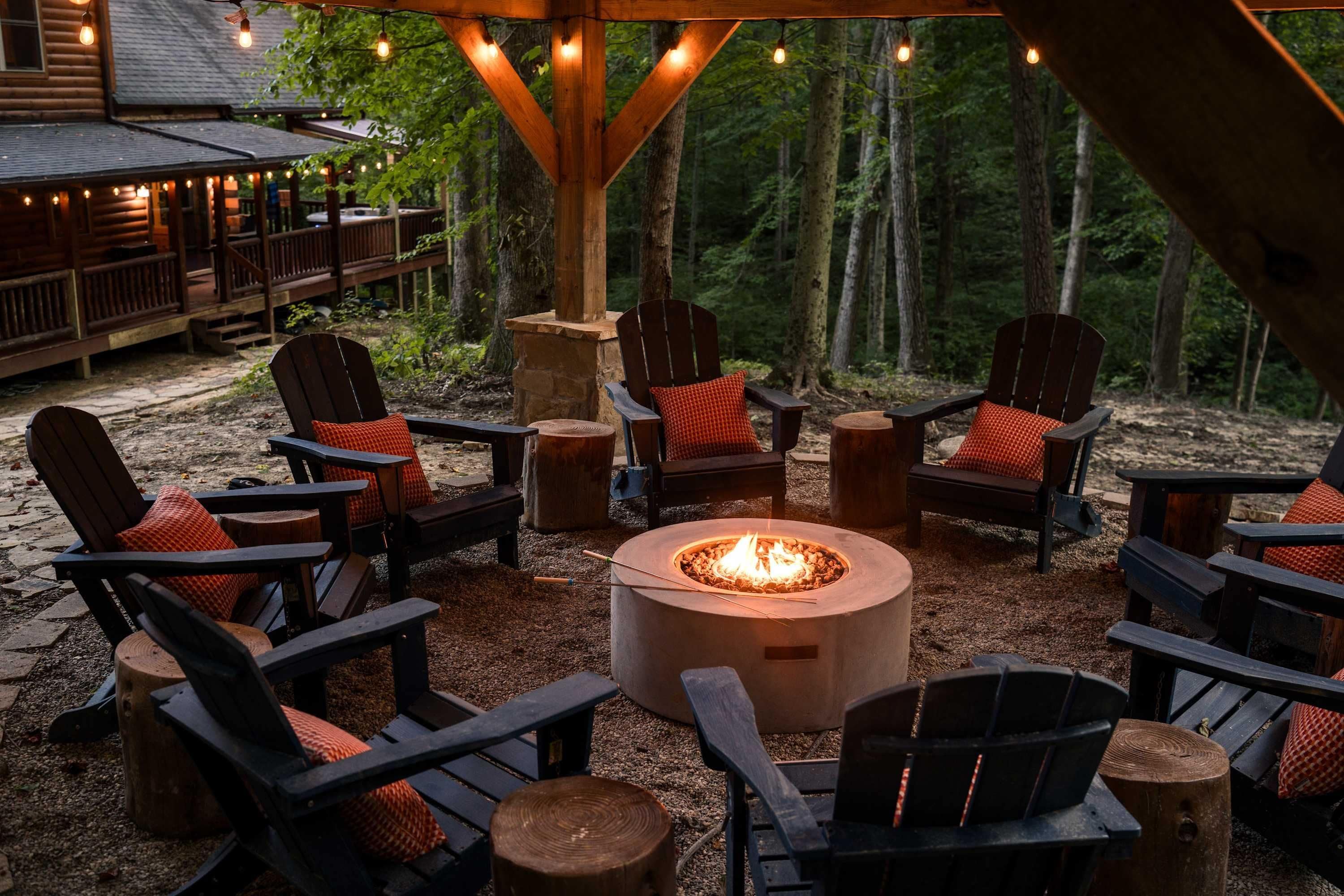An outdoor seating area with Adirondack chairs and a central fire pit.