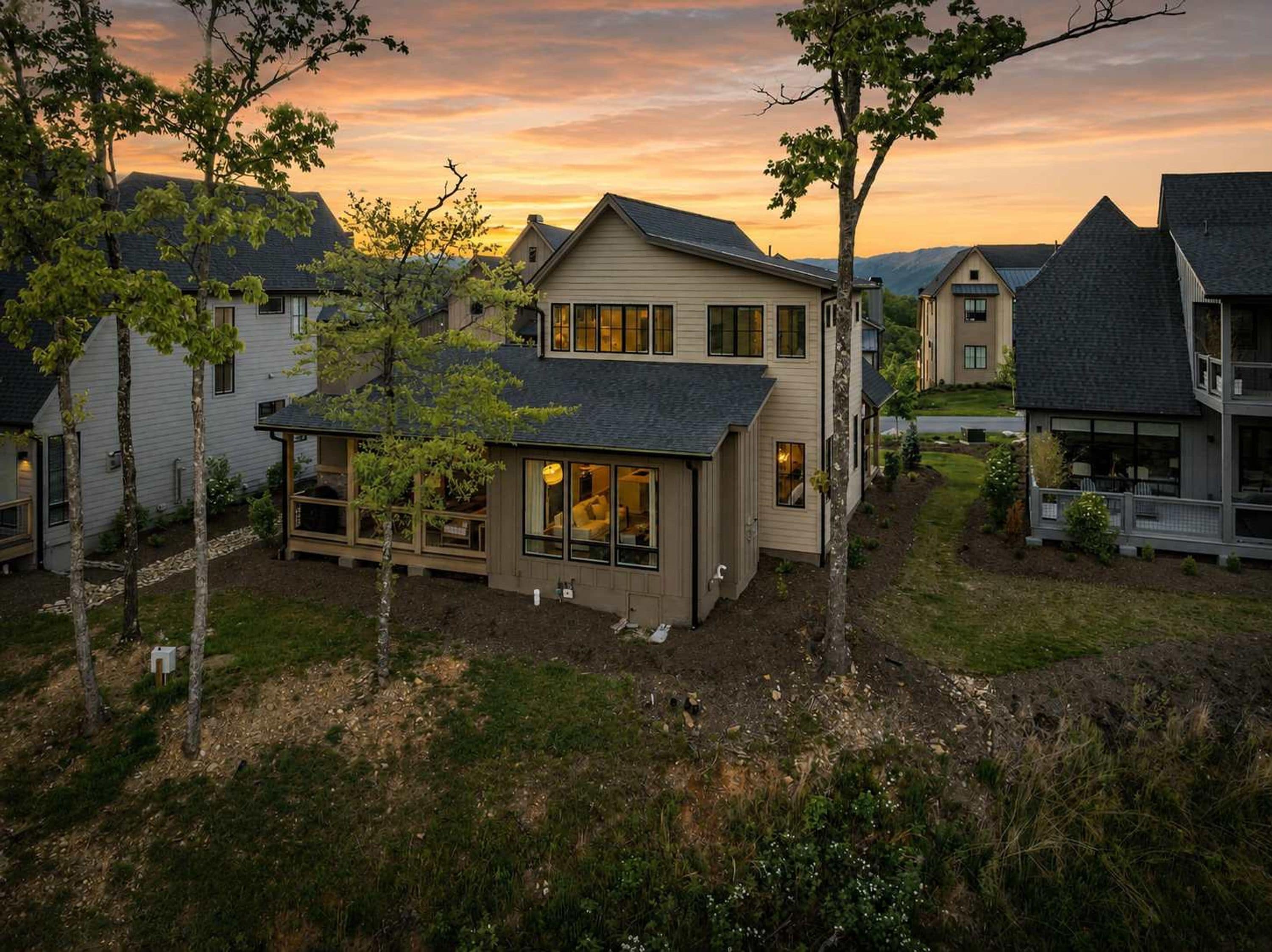 A residential house with a large front porch, a covered entryway, and a visible garage.
