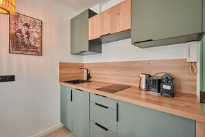 A kitchen with a wooden countertop, a sink, and a coffee maker. - Charming Studio Center of Paris-Montorgueil (Paris)