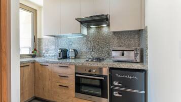 A modern kitchen with granite countertops, stainless steel appliances, and wooden cabinets.