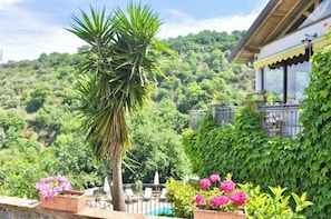 A residential property with a view of a lush green hillside, a swimming pool, and a balcony with outdoor furniture. - Farmhouse with panoramic swimming pool in Gioiosa Marea (Gioiosa Marea)