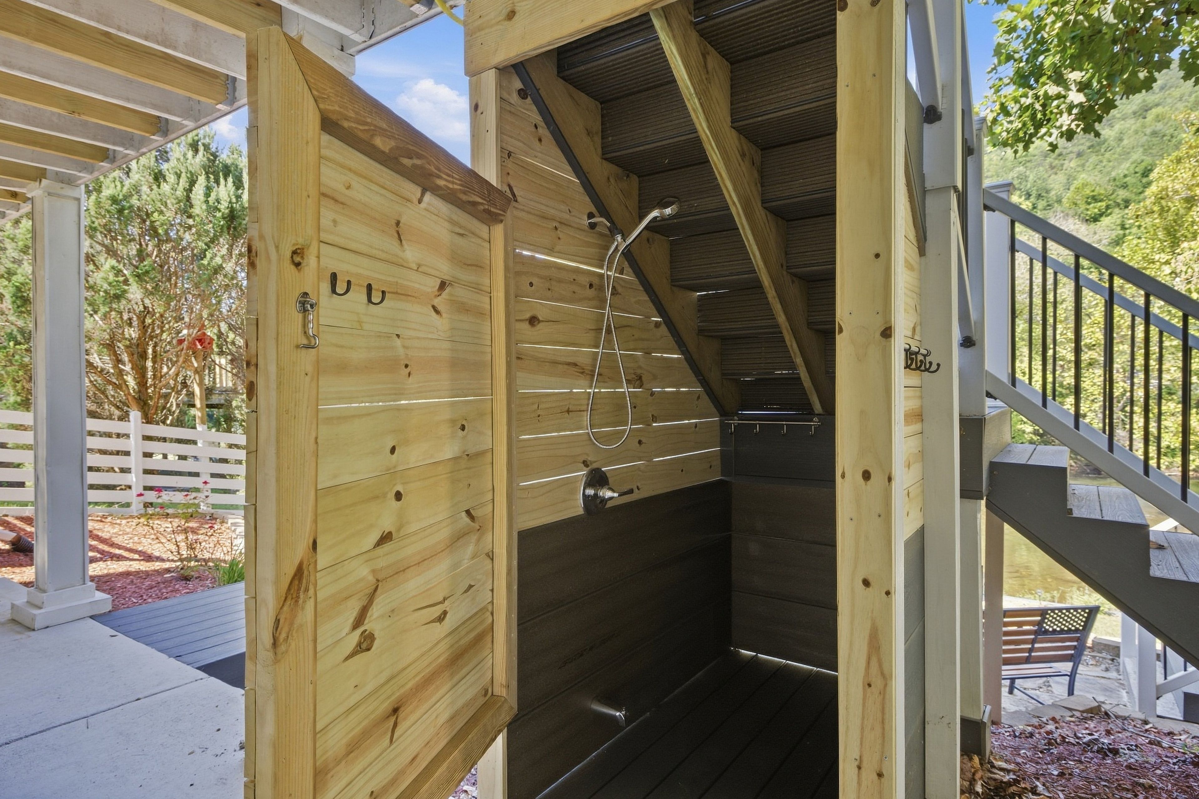 A wooden structure with a metal staircase and a shower area.